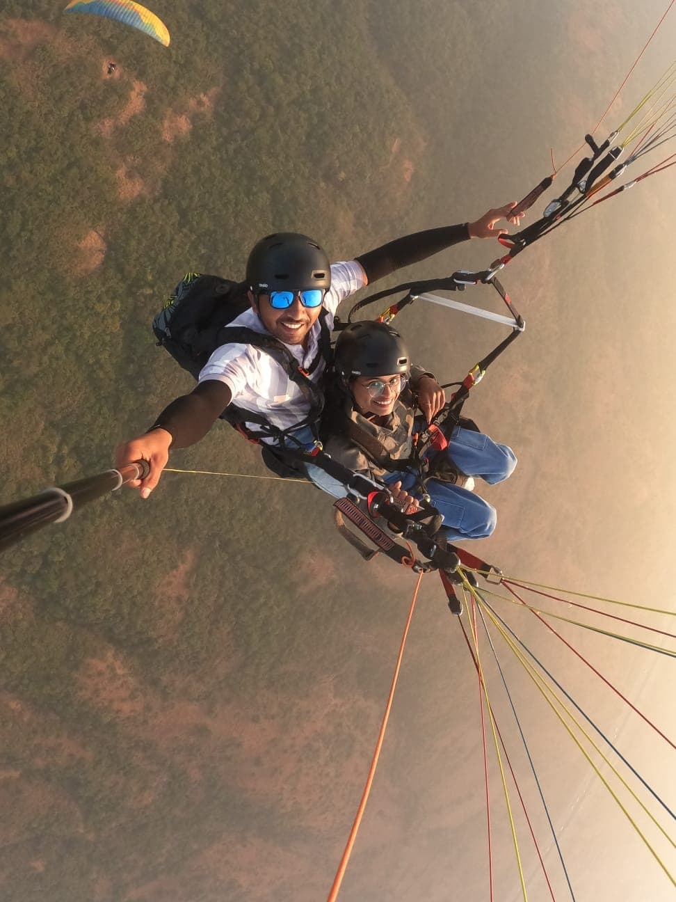 Instructional tandem paragliding where passenger learns to steer at Kamshet
