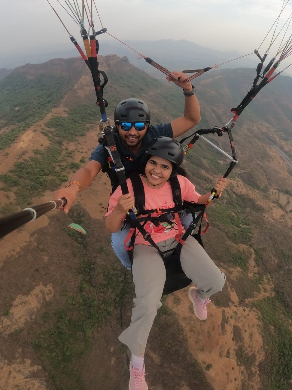 Thrilled first-time flyer enjoying tandem paragliding in Kamshet