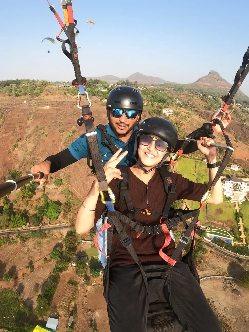 Paraglider soaring above Kamshet hills on a clear winter morning