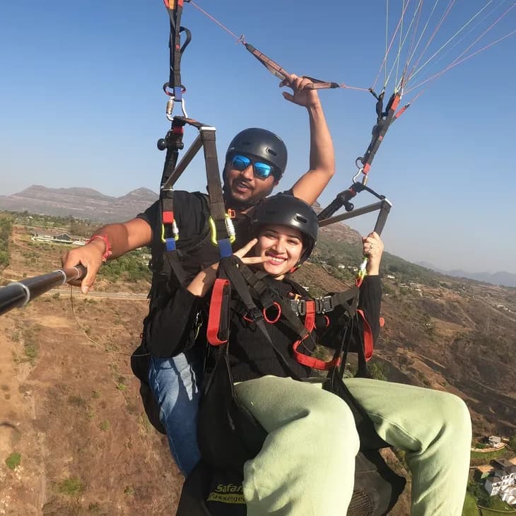 Tandem paragliding flight over the green hills of Kamshet near Pune